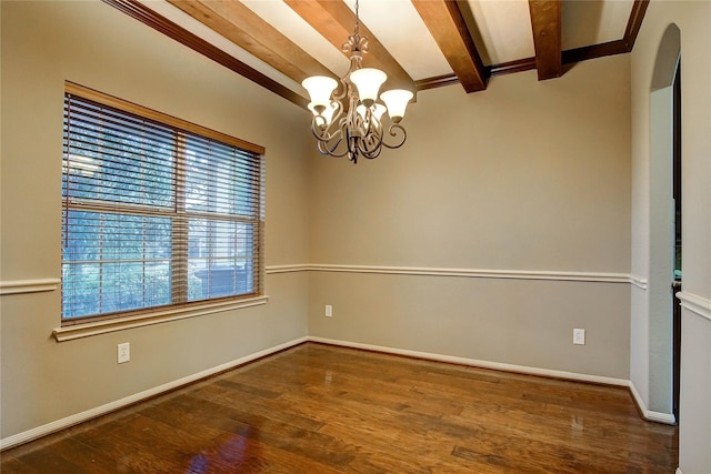 spare room featuring arched walkways, an inviting chandelier, wood finished floors, beamed ceiling, and baseboards