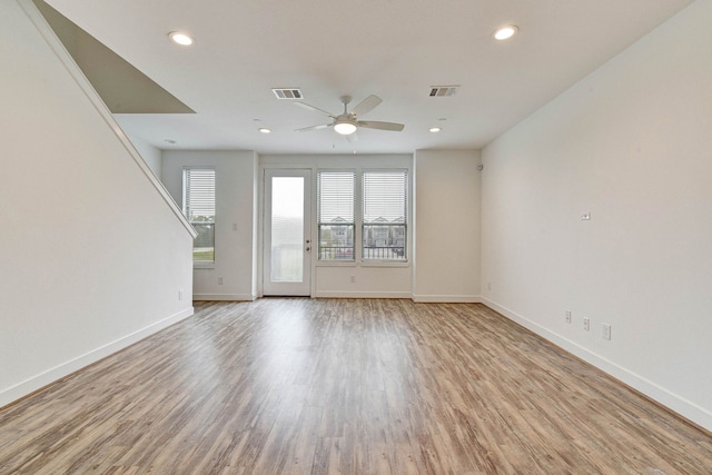 spare room featuring recessed lighting, wood finished floors, visible vents, and baseboards