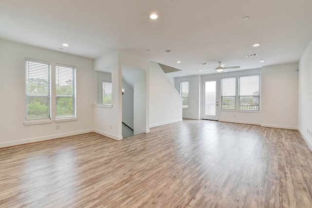 spare room featuring light wood finished floors, visible vents, baseboards, and recessed lighting