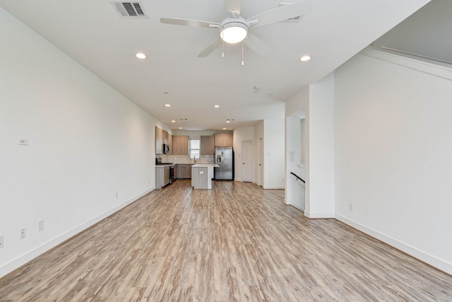 unfurnished living room featuring light wood finished floors, recessed lighting, visible vents, ceiling fan, and baseboards