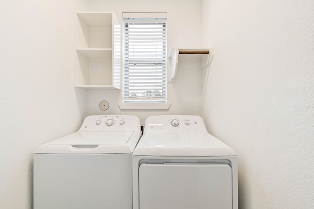 washroom featuring laundry area and washing machine and clothes dryer