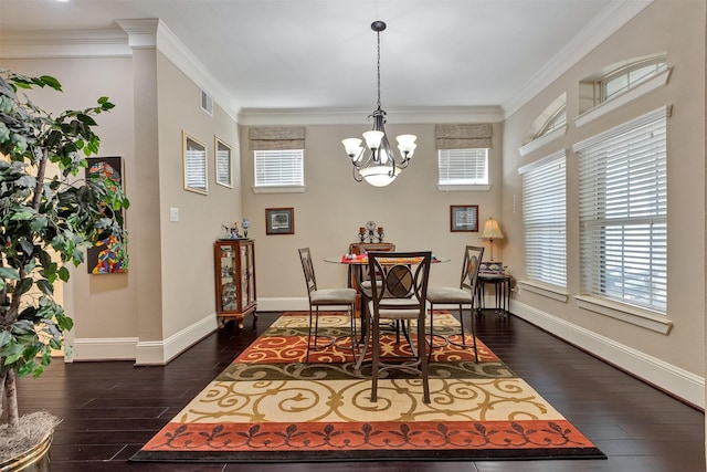 dining space with dark wood finished floors, crown molding, baseboards, and a wealth of natural light