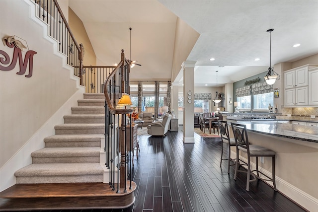 stairs with recessed lighting, baseboards, and wood finished floors