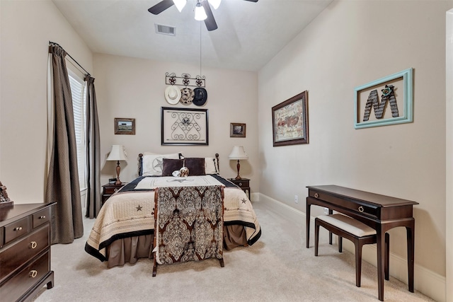 bedroom featuring light carpet, visible vents, a ceiling fan, and baseboards