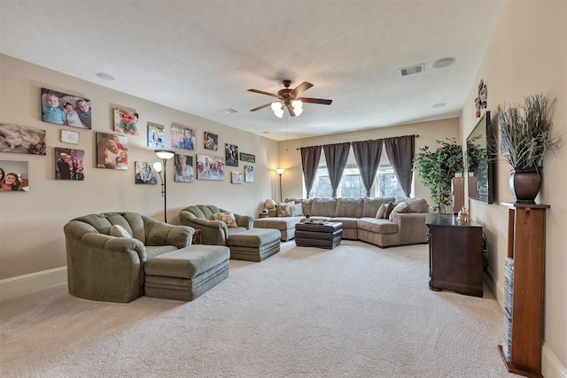 carpeted living area featuring visible vents, baseboards, and a ceiling fan