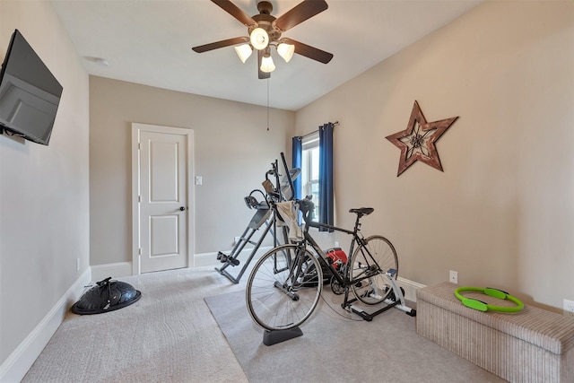 workout area with carpet flooring, a ceiling fan, and baseboards