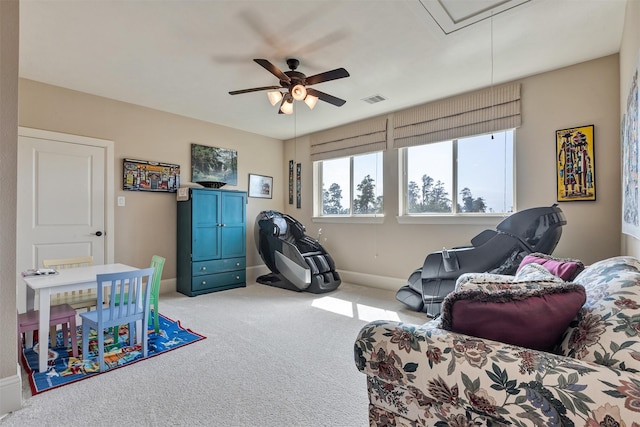 recreation room with baseboards, visible vents, attic access, ceiling fan, and carpet flooring