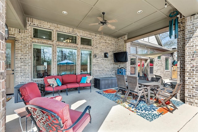 view of patio / terrace featuring outdoor dining space, an outdoor living space, and a ceiling fan