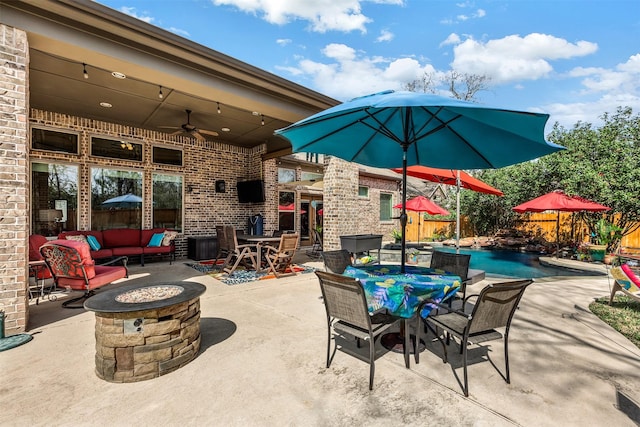 view of patio / terrace featuring an outdoor pool, outdoor dining area, a ceiling fan, and fence