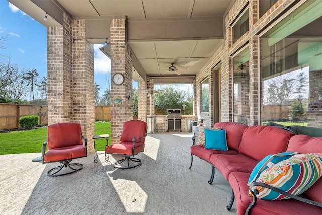 view of patio / terrace featuring a ceiling fan, exterior kitchen, grilling area, outdoor lounge area, and fence private yard