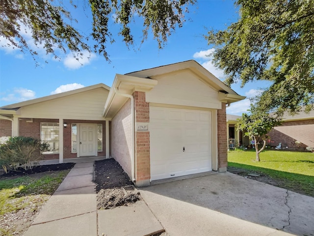 single story home featuring a front yard, brick siding, driveway, and an attached garage