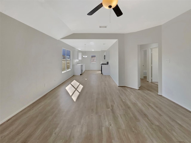 unfurnished living room featuring light wood finished floors, visible vents, and a ceiling fan