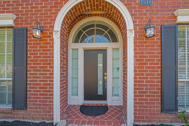 property entrance featuring brick siding