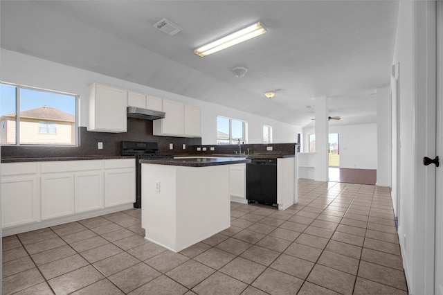 kitchen featuring light tile patterned flooring, under cabinet range hood, visible vents, dishwasher, and range with gas cooktop