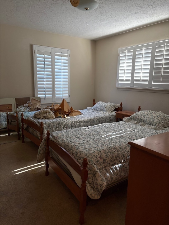 carpeted bedroom with a textured ceiling