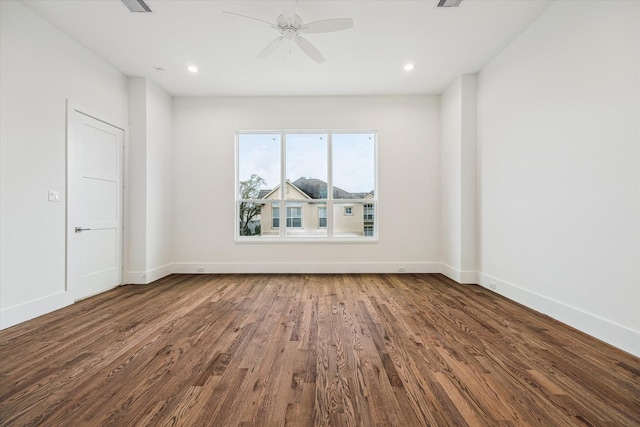 empty room with ceiling fan, baseboards, and wood finished floors