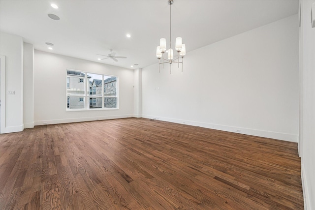 unfurnished room featuring ceiling fan with notable chandelier, recessed lighting, baseboards, and wood finished floors