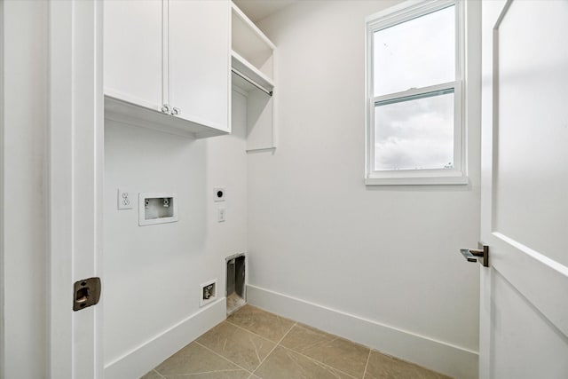 clothes washing area with cabinet space, light tile patterned floors, baseboards, hookup for a washing machine, and hookup for an electric dryer