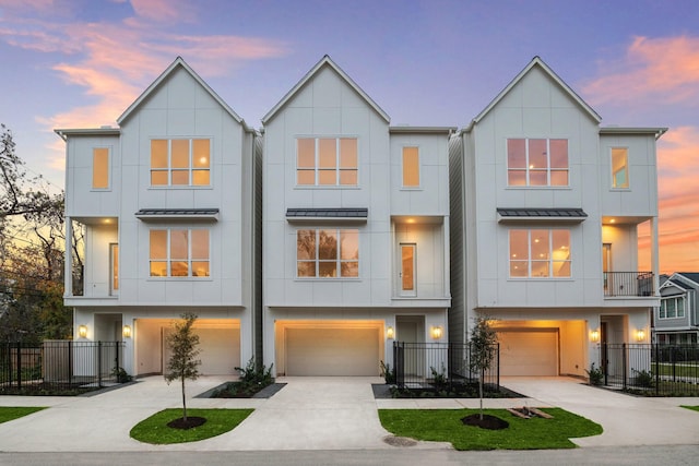 townhome / multi-family property with a standing seam roof, board and batten siding, and fence