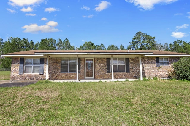 ranch-style house with a front lawn and brick siding