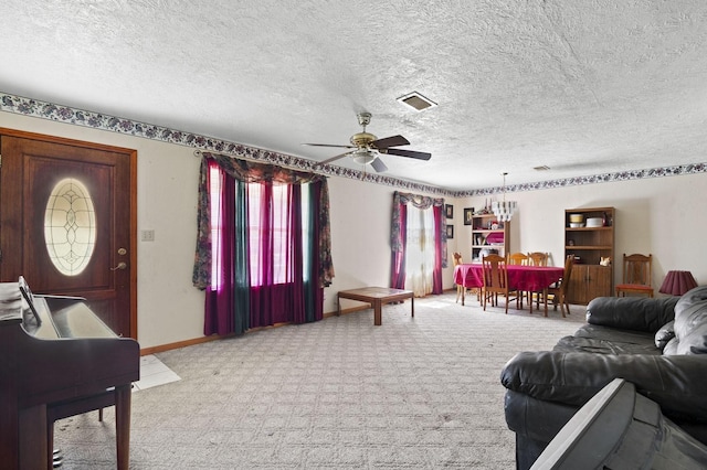 living area featuring ceiling fan, a textured ceiling, light carpet, visible vents, and baseboards