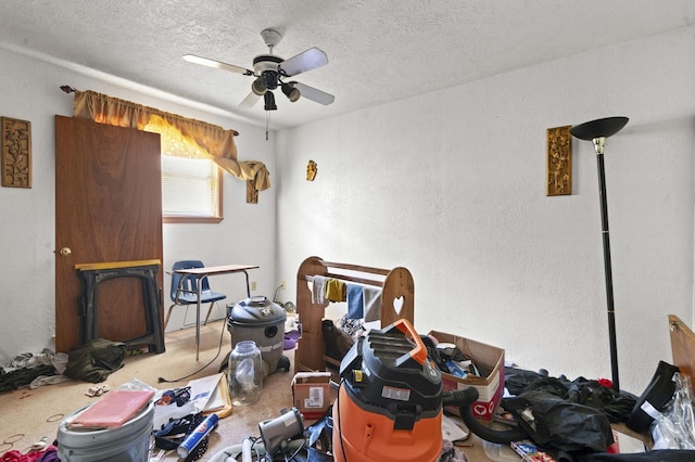 interior space with a ceiling fan and a textured ceiling