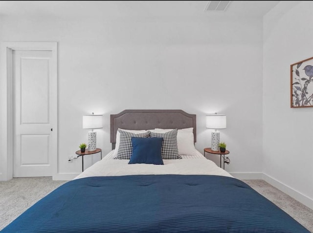 bedroom featuring carpet flooring, visible vents, and baseboards