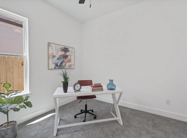 home office with carpet, a ceiling fan, and baseboards