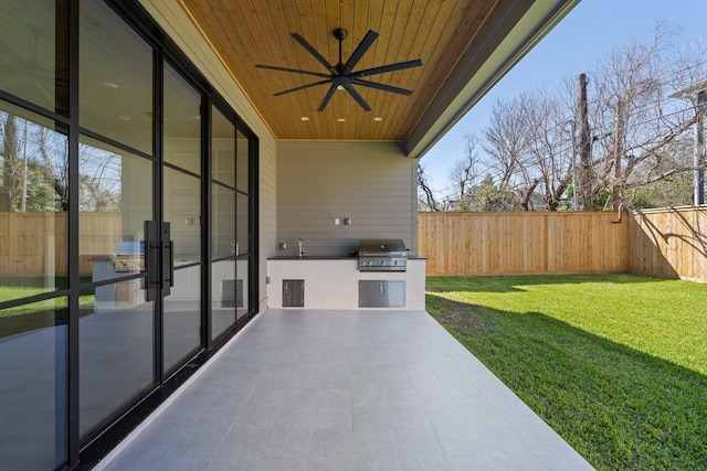 view of patio / terrace featuring area for grilling, a grill, a ceiling fan, and a fenced backyard