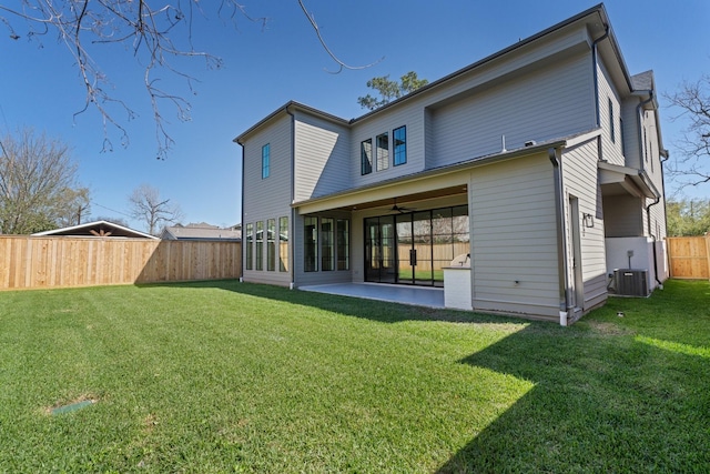 back of house with a patio, a lawn, central AC, and a fenced backyard