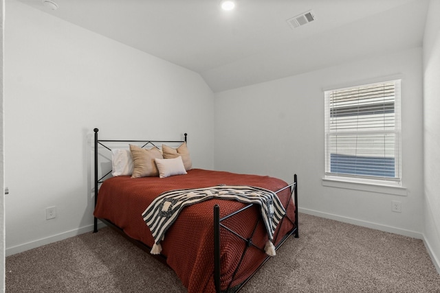 carpeted bedroom with lofted ceiling, visible vents, and baseboards