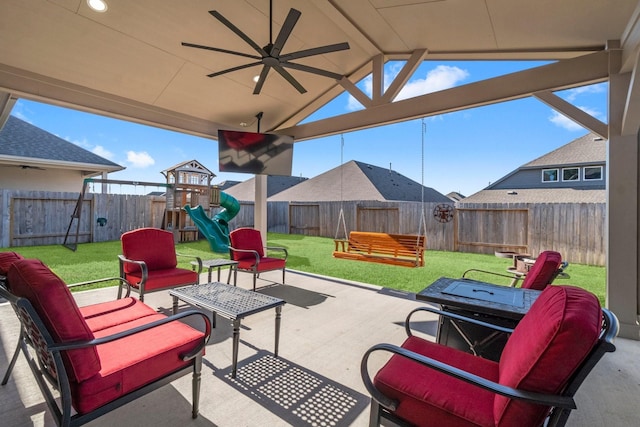 view of patio with ceiling fan, a playground, a fenced backyard, and an outdoor living space