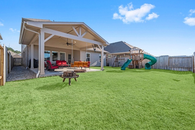 rear view of house with ceiling fan, a playground, a fenced backyard, a lawn, and a patio area