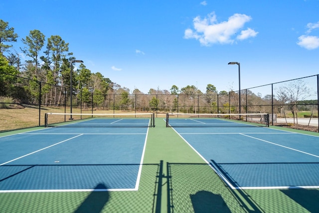 view of sport court featuring fence