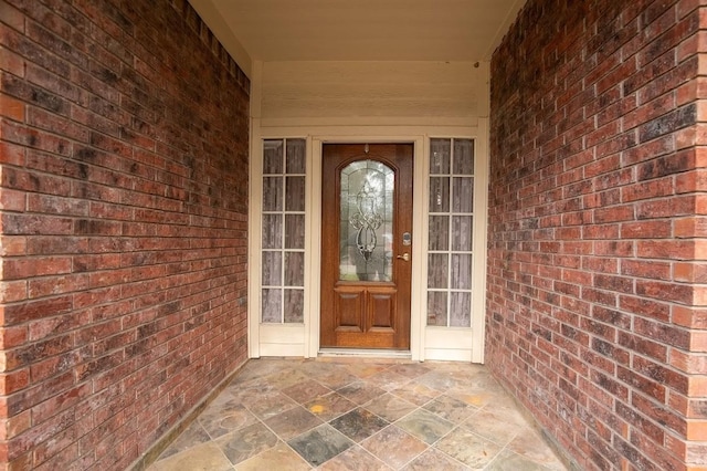 property entrance with brick siding