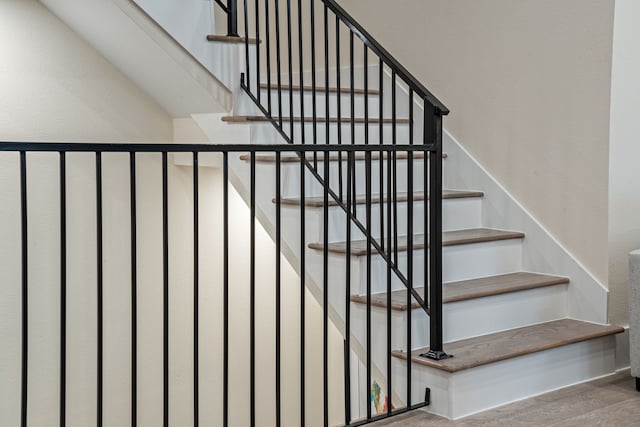 stairs featuring wood finished floors