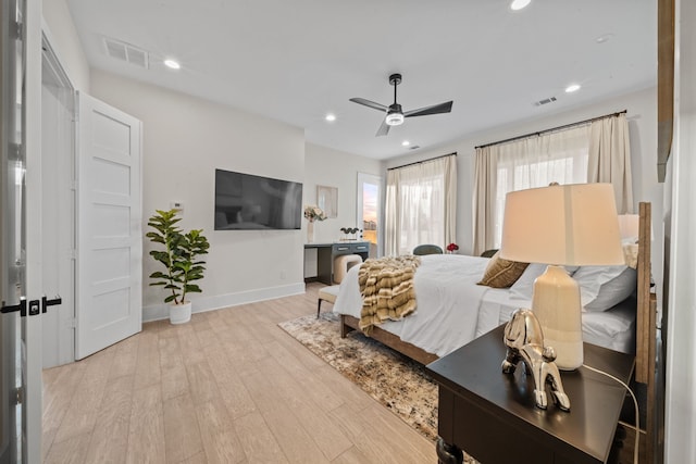 bedroom featuring baseboards, visible vents, wood finished floors, and recessed lighting