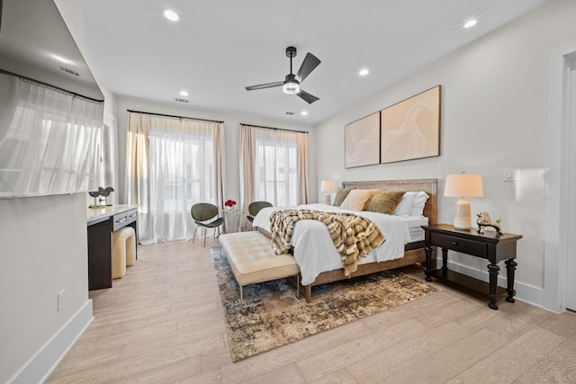 bedroom with light wood-type flooring, ceiling fan, baseboards, and recessed lighting