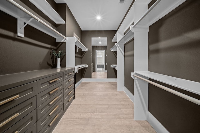 spacious closet with light wood finished floors and visible vents