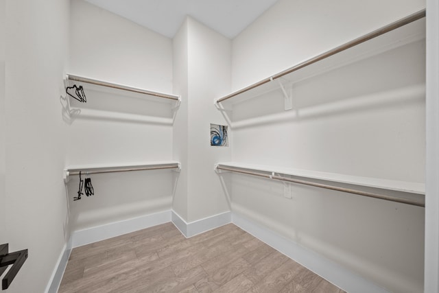 spacious closet with wood finished floors