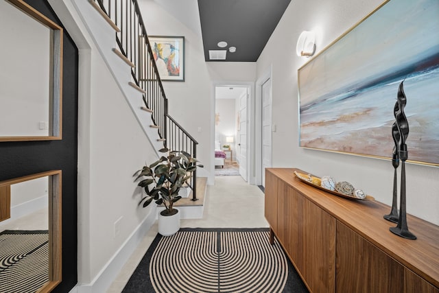 entrance foyer with stairs and baseboards