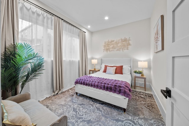 bedroom featuring recessed lighting, multiple windows, and baseboards