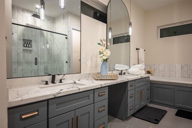 915 Thompson St, Houston, TX 77007 - full bath featuring double vanity, a sink, a shower stall, a bath, and tile patterned floors