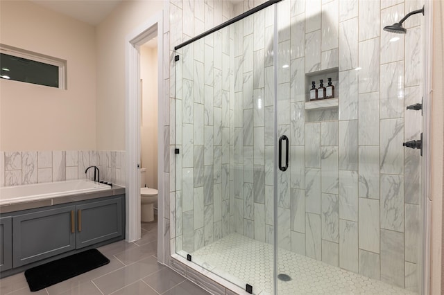 915 Thompson St, Houston, TX 77007 - bathroom featuring a stall shower, toilet, and tile patterned floors