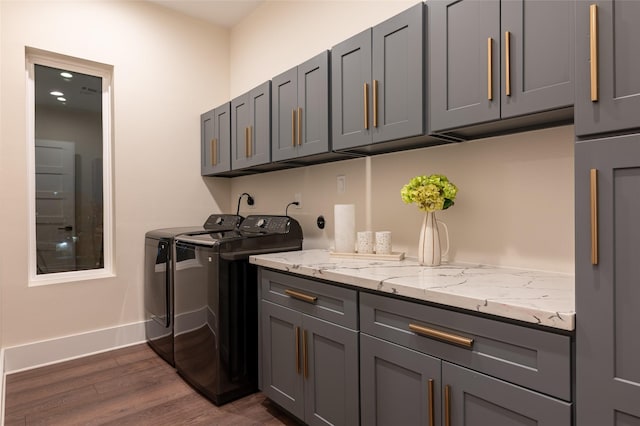 915 Thompson St, Houston, TX 77007 - laundry area featuring cabinet space, baseboards, dark wood-type flooring, and washer and dryer