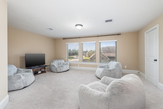 living room with baseboards, visible vents, and carpet flooring