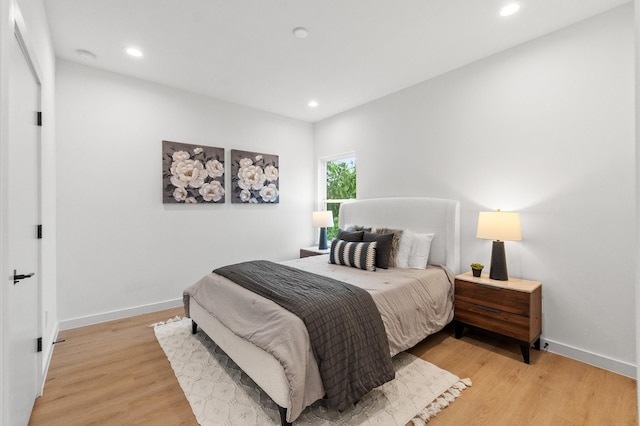 bedroom with recessed lighting, baseboards, and light wood finished floors