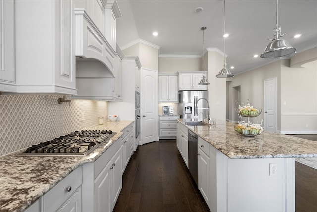 kitchen with white cabinets, light stone counters, appliances with stainless steel finishes, dark wood-style flooring, and backsplash