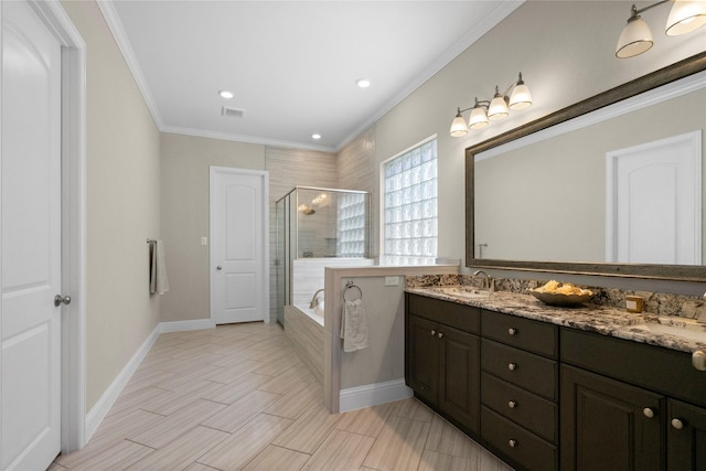 bathroom featuring double vanity, a stall shower, a garden tub, crown molding, and a sink