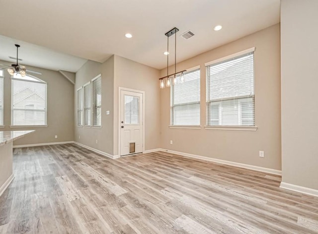 interior space with recessed lighting, baseboards, visible vents, and light wood finished floors